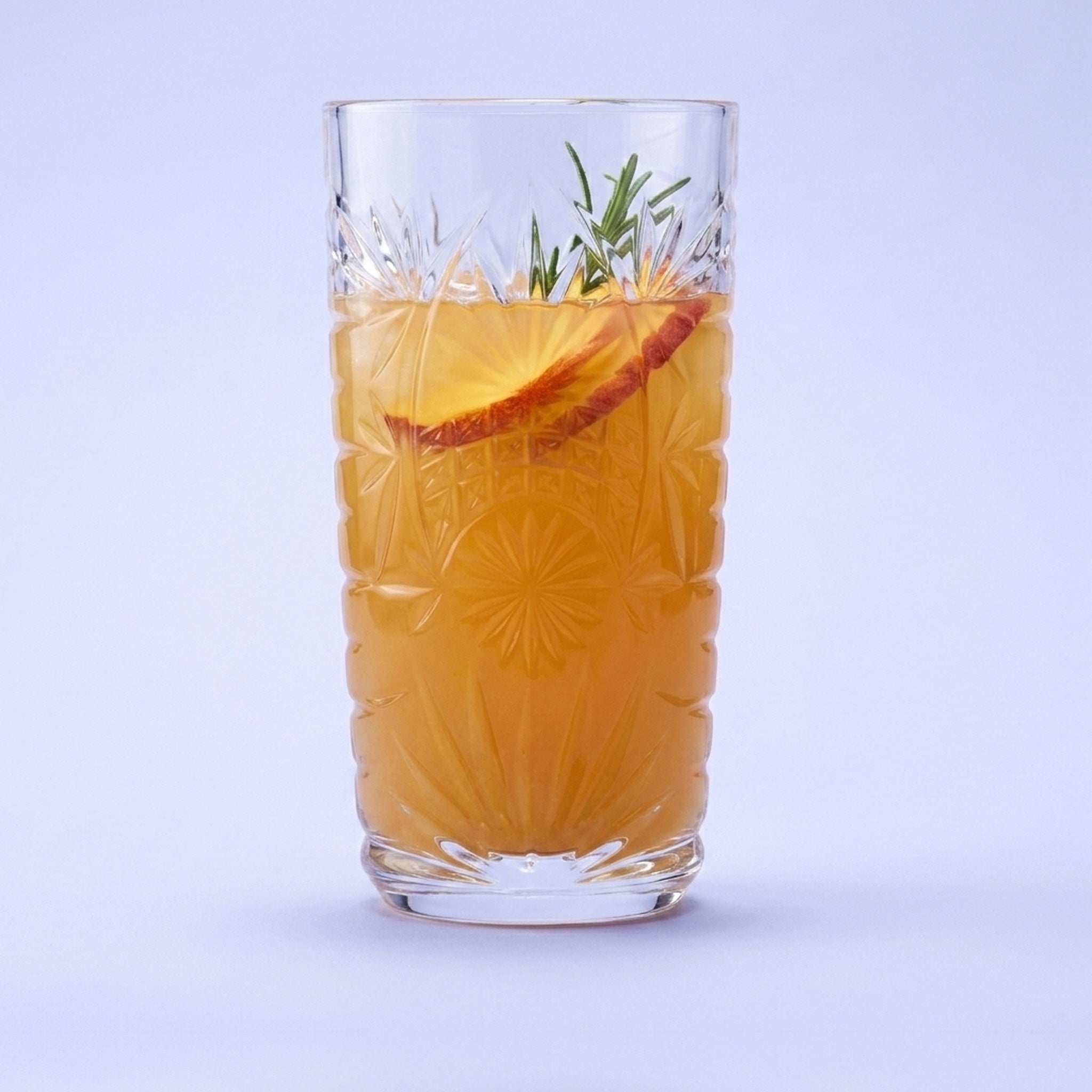 Royal Leerdam Starla longdrinkglas 27 cl gevuld met perzik-abrikooslimonade en rozemarijn